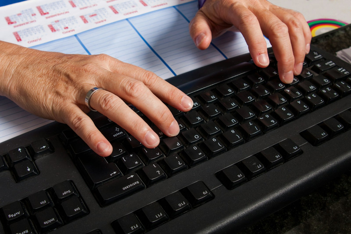 Person adjusting their seated position at a home office desk
