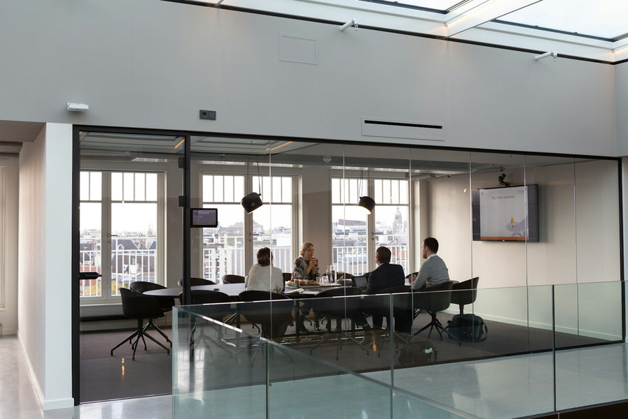 People sitting on office chairs with back support in a meeting room