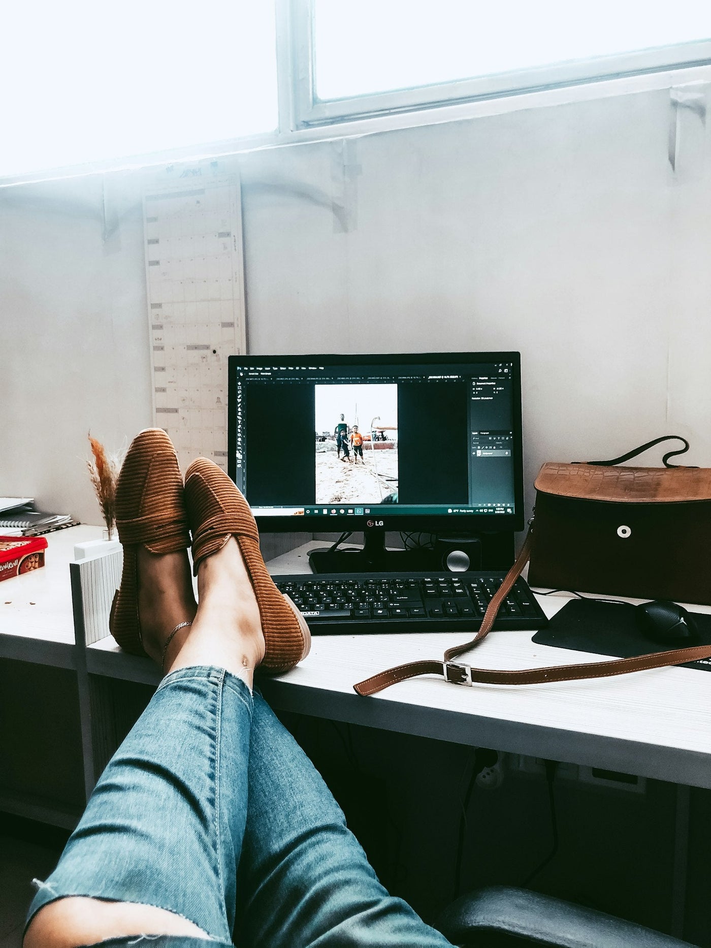 Feet resting on an under-desk footrest