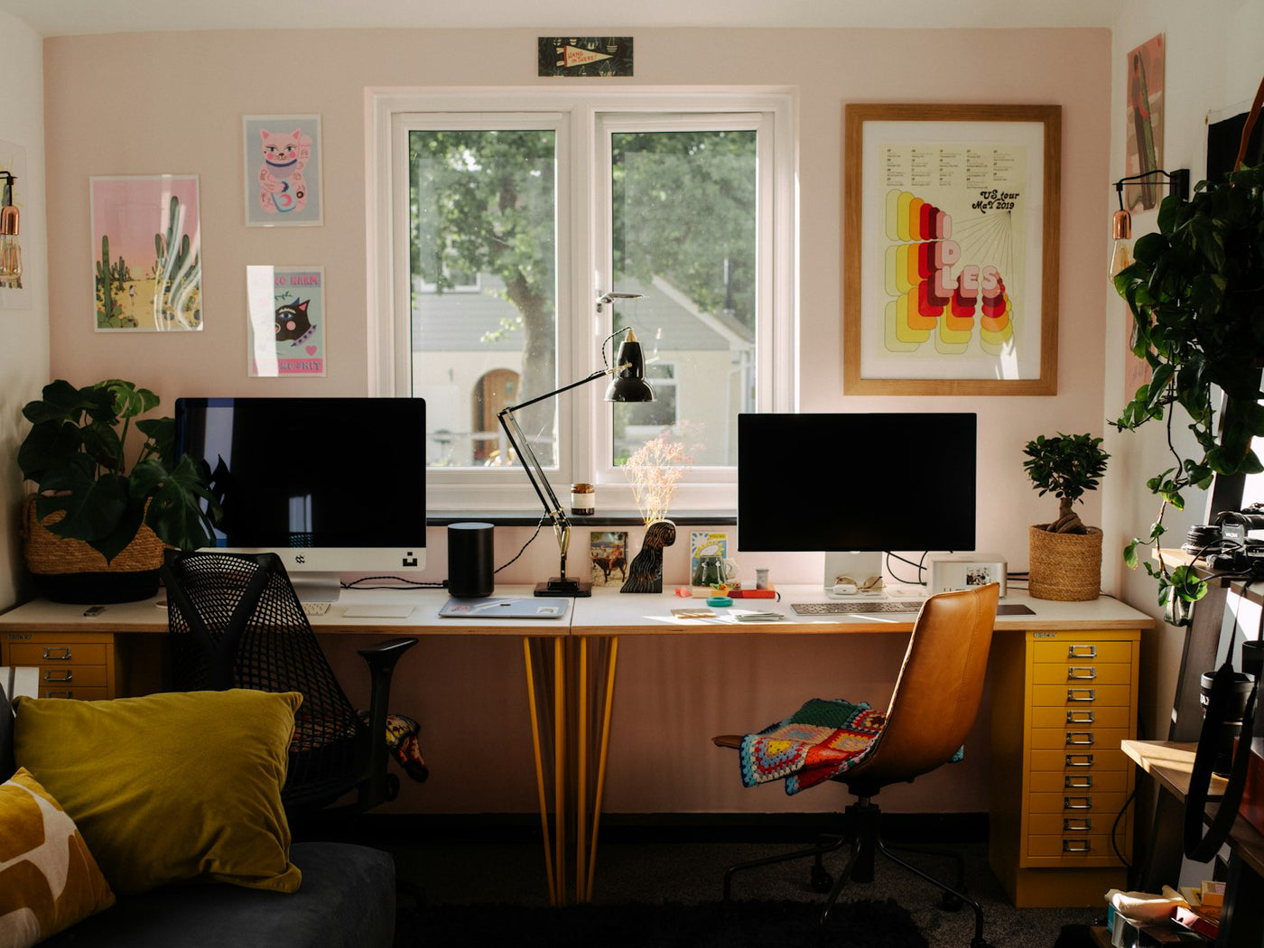 A desk with two computer monitors and a chair
