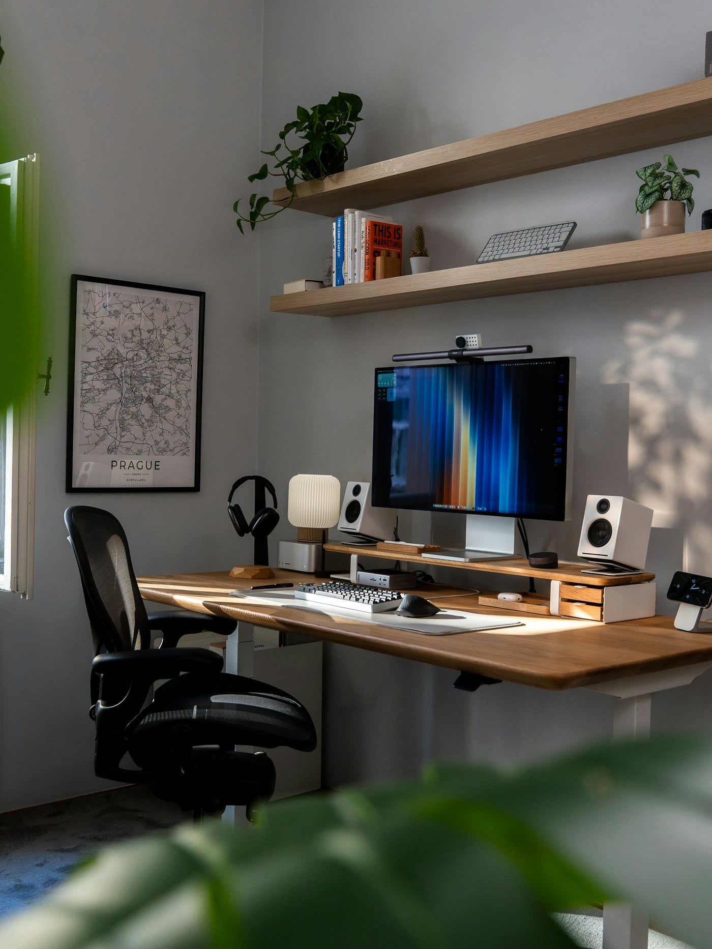 A modern home office desk setup with computer and plants for focused remote work